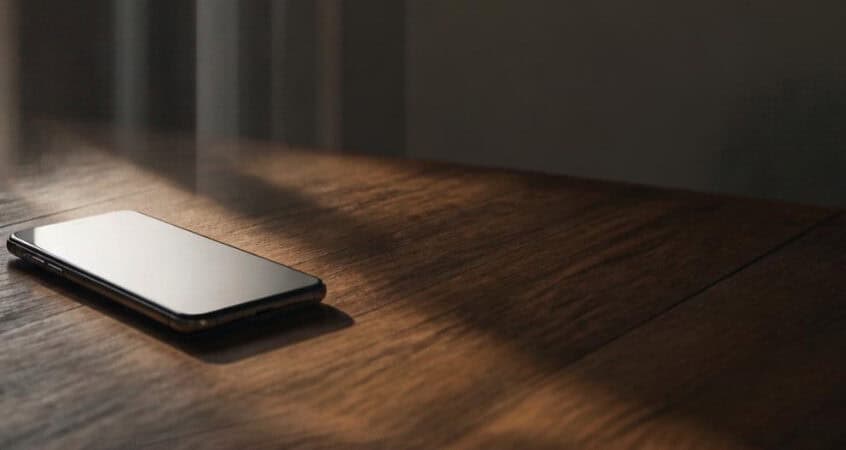 Open window beside a smartphone representing TN visa social media review